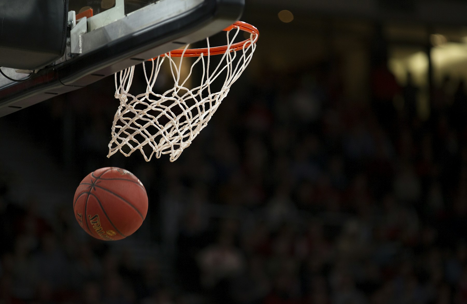 Basketball dropping through an outdoor hoop